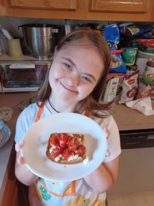 girl holding bruschetta
