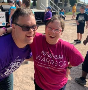 Two adults with Down Syndrome smiling