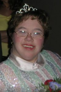 adult female with Down syndrome smiling in tiara